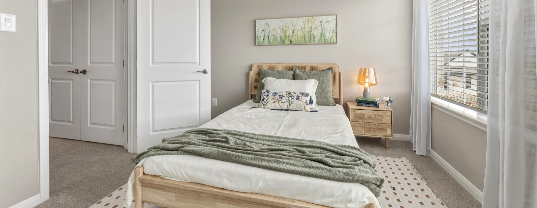 a bedroom with a bed and a lamp