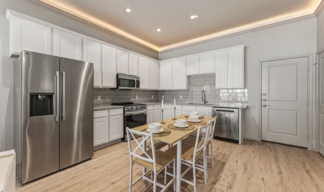 a kitchen with white cabinets