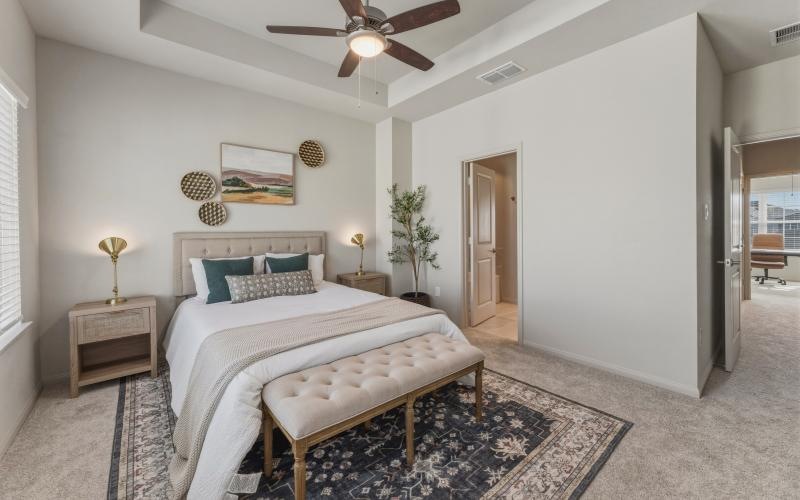 a bedroom with a bed and a fan