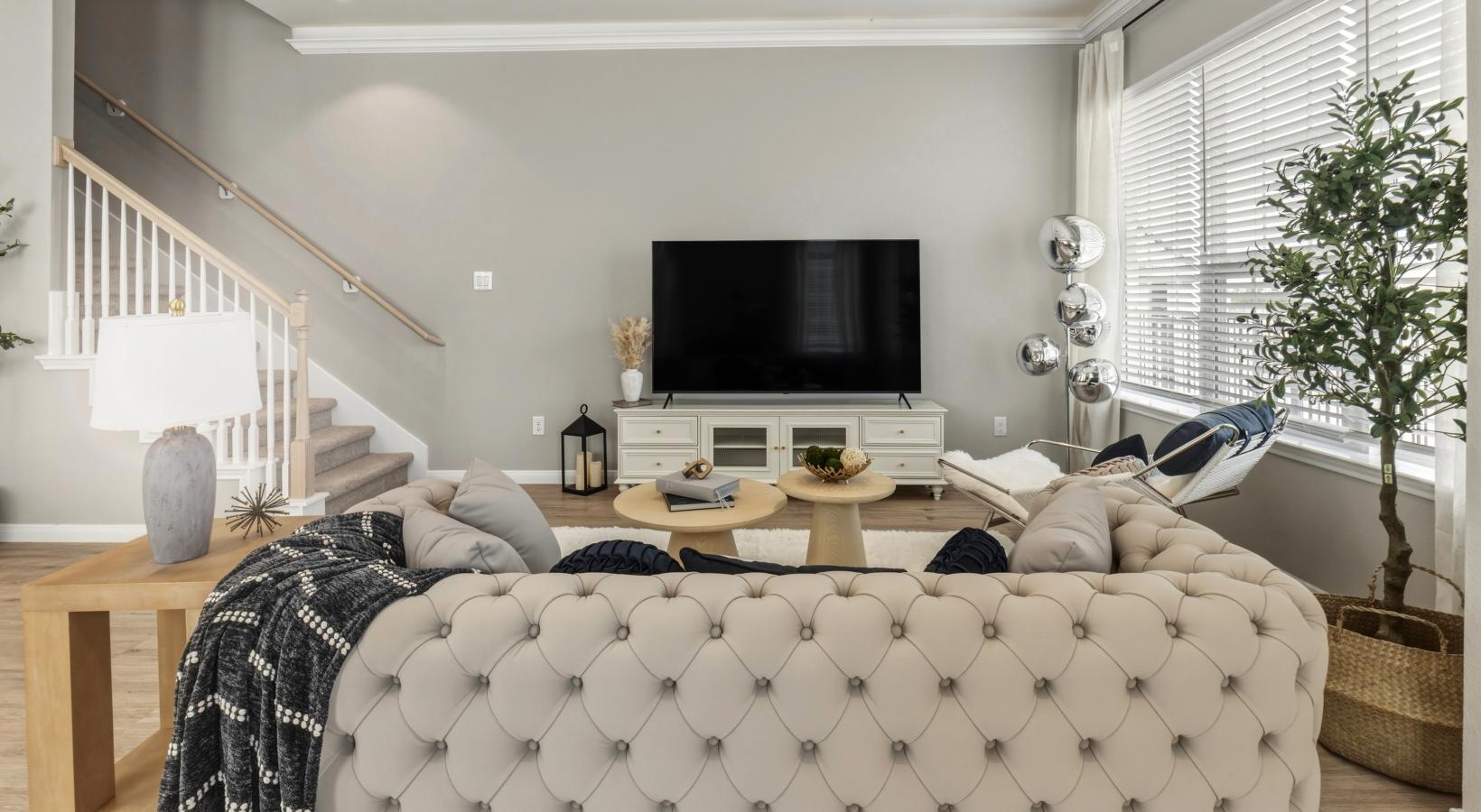 a living room with a large tv and a couch
